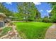 Beautifully landscaped backyard featuring a spacious lawn area with a mature tree and well-maintained surroundings at 962 S Potomac Way, Aurora, CO 80012