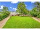 Large, lush backyard featuring a well-maintained lawn and mature trees at 962 S Potomac Way, Aurora, CO 80012