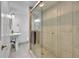 Beautiful bathroom featuring modern fixtures, glass-enclosed shower, and a pedestal sink at 962 S Potomac Way, Aurora, CO 80012