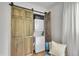 Handy laundry closet featuring wooden barn doors and modern washer/dryer at 962 S Potomac Way, Aurora, CO 80012