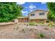 Charming brick and siding home with a blue front door and neatly landscaped yard at 962 S Potomac Way, Aurora, CO 80012
