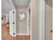 Inviting hallway featuring hardwood floors and an attractive mirror adds charm at 962 S Potomac Way, Aurora, CO 80012