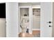 Bright hallway with hardwood floors leading to storage and stairs at 962 S Potomac Way, Aurora, CO 80012