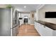 Stylish kitchen with stainless steel appliances, white cabinets, and wood-look flooring at 962 S Potomac Way, Aurora, CO 80012