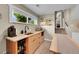 Basement kitchenette with stainless steel appliances, bar seating, and natural light at 962 S Potomac Way, Aurora, CO 80012