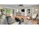 Open-concept living space featuring a comfortable seating area, bar, and connection to the kitchen at 962 S Potomac Way, Aurora, CO 80012