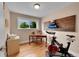 Home office with wood floors, bright window, and exercise equipment at 962 S Potomac Way, Aurora, CO 80012