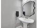 Chic powder room with a stylish mirror and pedestal sink at 962 S Potomac Way, Aurora, CO 80012