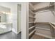 Bathroom featuring dual sinks, modern fixtures, and a walk-in closet, creating a functional space at 21234 E 63Rd Dr, Aurora, CO 80019