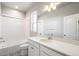 This bathroom has a shower and tub, a large mirror, and decorative floor tiles at 21234 E 63Rd Dr, Aurora, CO 80019