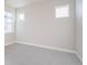 A bright bedroom with neutral carpet, base trim, and walls at 21234 E 63Rd Dr, Aurora, CO 80019