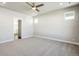 Bright bedroom with neutral walls, carpet flooring, ceiling fan, and natural light from the windows at 21234 E 63Rd Dr, Aurora, CO 80019