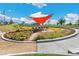 Outdoor common area with seating, lush landscaping, a shade structure, and pink flowers at 21234 E 63Rd Dr, Aurora, CO 80019