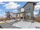New construction home with stone accents, covered porch, and professionally landscaped yard at 21234 E 63Rd Dr, Aurora, CO 80019