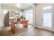 Bright home office featuring a wooden desk, built-in shelving, and a large window at 21234 E 63Rd Dr, Aurora, CO 80019
