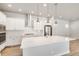 Modern kitchen featuring stainless steel appliances, island with sink, and bright white countertops at 21234 E 63Rd Dr, Aurora, CO 80019