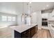 Modern kitchen with stainless steel appliances, gas range, quartz counters, and an island sink at 21234 E 63Rd Dr, Aurora, CO 80019