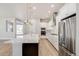 Bright kitchen with white cabinets, stainless steel appliances, and a large island with seating at 21234 E 63Rd Dr, Aurora, CO 80019