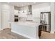 Modern kitchen featuring stainless appliances, white cabinetry, and center island with quartz countertop at 21234 E 63Rd Dr, Aurora, CO 80019