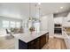 Modern kitchen with stainless steel appliances, quartz countertops, and a large center island at 21234 E 63Rd Dr, Aurora, CO 80019