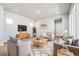 Inviting living room with wood floors, neutral tones, recessed lighting, and stylish furnishings at 21234 E 63Rd Dr, Aurora, CO 80019