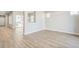 Open-concept living room with light wood floors, and neutral walls, creating a bright and airy space at 21234 E 63Rd Dr, Aurora, CO 80019