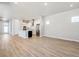 Open-concept living space featuring a modern kitchen with stainless steel appliances and hardwood floors at 21234 E 63Rd Dr, Aurora, CO 80019