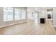 Open-concept living area with hardwood floors connecting living, dining, and modern kitchen spaces at 21234 E 63Rd Dr, Aurora, CO 80019