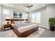Serene main bedroom with a plush bed, stylish decor, and ample natural light from a large window at 21234 E 63Rd Dr, Aurora, CO 80019