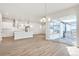 Bright, open-concept kitchen and dining area with contemporary finishes and abundant natural light at 21234 E 63Rd Dr, Aurora, CO 80019