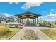 Community outdoor pavilion area featuring picnic tables, a fireplace, and open design at 21234 E 63Rd Dr, Aurora, CO 80019