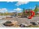 Community playground featuring a slide, climbing structure, basketball hoop, and modern concrete design at 21234 E 63Rd Dr, Aurora, CO 80019