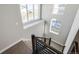 Stairwell featuring modern railings, neutral walls, and carpeted stairs, creating a transition between floors at 21234 E 63Rd Dr, Aurora, CO 80019