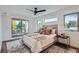 Bright main bedroom with a sliding glass door to a private balcony, complemented by stylish decor and ample natural light at 4476 Utica St, Denver, CO 80212