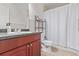 Bathroom featuring a single sink vanity and shower with white curtain at 249 Vista Blvd, Brighton, CO 80603