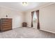 Bedroom with neutral walls and carpet, complemented by dark wood furniture at 249 Vista Blvd, Brighton, CO 80603