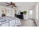 Cozy bedroom with ceiling fan, wood floors, and sliding door to the outside at 249 Vista Blvd, Brighton, CO 80603