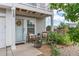 Inviting front porch seating, plants and a sunflower wreath create a warm welcome to this home at 249 Vista Blvd, Brighton, CO 80603