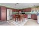 Spacious kitchen features stainless steel appliances, dark cabinets, a table and access to the yard at 249 Vista Blvd, Brighton, CO 80603