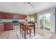 Eat-in kitchen with stainless steel appliances, dark cabinets, and a sliding glass door to backyard at 249 Vista Blvd, Brighton, CO 80603