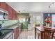 Bright kitchen with stainless steel appliances and a kitchen table adjacent to a sliding glass door at 249 Vista Blvd, Brighton, CO 80603