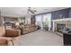 Open-concept living area with a fireplace, comfortable seating, and seamlessly connected to the kitchen at 249 Vista Blvd, Brighton, CO 80603