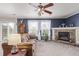 Cozy living room with a fireplace, plush sofa, and plenty of natural light at 249 Vista Blvd, Brighton, CO 80603