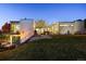 Modern home features an outdoor living area, manicured lawn, and outdoor staircase at 5969 S Humboldt Ct, Centennial, CO 80121