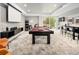 Spacious game room with pool table, bar, screen and exercise bike at 5969 S Humboldt Ct, Centennial, CO 80121