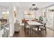 Stylish dining area with unique lighting fixture, hardwood floors, and contemporary art, adjacent to the kitchen at 5969 S Humboldt Ct, Centennial, CO 80121