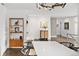 Dining area featuring modern lighting, sleek furniture, and an open layout with a view of the upstairs landing at 5969 S Humboldt Ct, Centennial, CO 80121