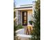 Modern front door surrounded by stone accents and greenery adds to the home's curb appeal at 5969 S Humboldt Ct, Centennial, CO 80121