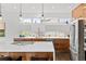 Bright kitchen featuring an island, updated appliances, wood cabinets, and a view of the backyard at 5969 S Humboldt Ct, Centennial, CO 80121