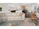 Spacious living room showcasing a plush sectional sofa, stylish area rug, and open layout to the kitchen at 5969 S Humboldt Ct, Centennial, CO 80121